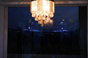 a chandelier in a window at night at Hotel Brundavan Homes in Hyderabad