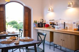 a kitchen with two tables and a counter with a counter at Le Tartane B&b Guidaloca in Castellammare del Golfo