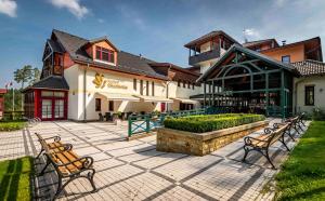 a group of benches in front of a building at Hotel Studanka in Rychnov nad Kněžnou