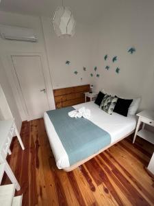 a bedroom with a bed with birds on the wall at 262 Baixa Guesthouse in Lisbon