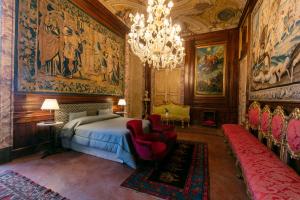 a bedroom with a bed and a chandelier at Palazzo Doria Napoli in Naples