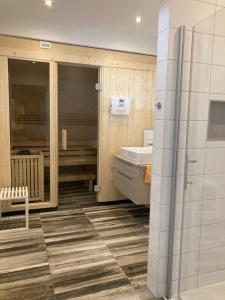 a bathroom with a sink and a toilet and a mirror at Villa Kleine Welle in Trent +7 photos