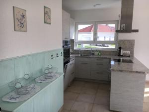 a kitchen with white cabinets and a counter top at Villa Kleine Welle in Trent