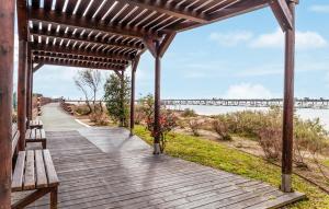 a wooden walkway with a bench and a bridge at Vive Huelva ARAGON 4 HABITACIONES WIFI 300MB in Huelva