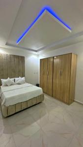 a bedroom with a large bed with a blue light at Geminge shortlet in Port Harcourt
