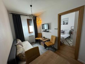 a living room with a couch and a bed and a mirror at Jahorina 7Lux in Jahorina