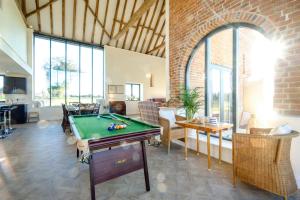 a living room with a pool table in it at Upper Barn in Ufford