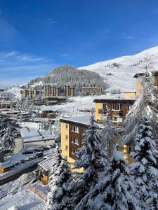 a town with snow covered trees and buildings at Vallonpierre2 in Orcières