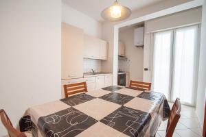 a kitchen with a table and a table and chairs at APPARTAMENTI SIVIGLIA in Cattolica