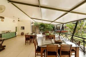 a dining room with a table and some chairs at Lhasa Ayurveda and Wellness Resort - A BluSalzz Collection, Kochi, Kerala in Cochin