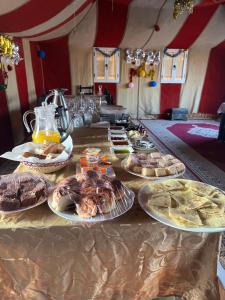 a table with many plates of food on it at Central Camp in Merzouga