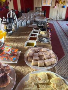 a long table filled with different types of food at Central Camp in Merzouga