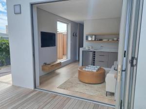 a view of a living room with a large sliding glass door at Quaint Cottage in Hermanus