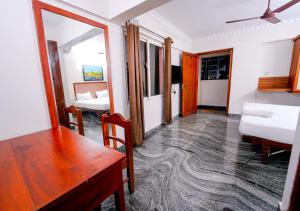 a room with a wooden table and a bedroom at POP TAVERN Delight by VOYE HOMES in Veli
