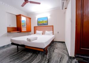 a bedroom with a large bed with white sheets at POP TAVERN Delight by VOYE HOMES in Veli