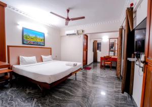 a bedroom with a bed and a flat screen tv at POP TAVERN Delight by VOYE HOMES in Veli