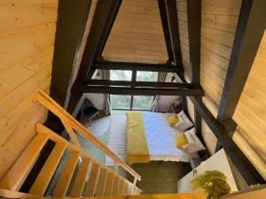 an overhead view of a room with a bed and a window at Forest A-frame-Porumbacu in Porumbacu de Sus