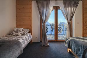 Posteľ alebo postele v izbe v ubytovaní Willa Pasieka Apartamenty Domki