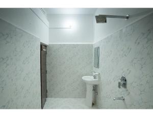 a bathroom with a sink and a toilet at Hotel Chouhan Palace, Jaisalmer, RJ in Jaisalmer