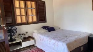 a small bedroom with a bed and a window at ACM Flat in Natal