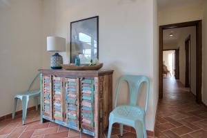 a room with two chairs and a dresser and a mirror at Le Domaine Saint François La Tour 3 in Ajaccio