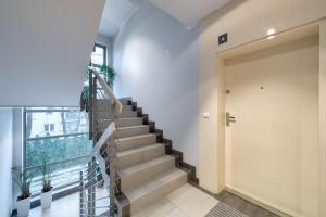 a hallway with stairs and a large window at Dom & House - Apartments Sopot Kamienny Potok in Sopot