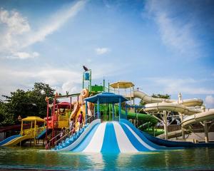 a water park with a water slide in the water at Fortune Home Service Apartment 3Bhk,E-28, Saket 2B in New Delhi