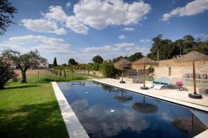 a swimming pool in a yard with at 139 e 140 Casa dos Carvalhos in Castelo Branco