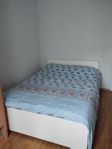 a bed with a blue comforter in a room at Angel's home in Dublin