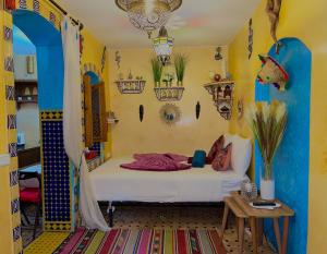 a bedroom with a bed in a room at Dar Sandra Moroccan Tiny House in Tangier