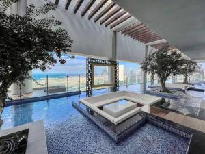 a large swimming pool with a table in a building at Luxurious one bedroom Apartment in Dubai