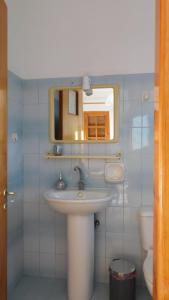 a bathroom with a sink and a mirror and a toilet at Thaleia view in Perdika
