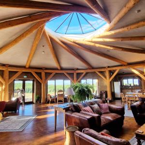 a living room with a ceiling with wooden beams at Lough Mardal Lodge in Donegal