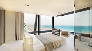 a bedroom with a bed and a view of the ocean at Victoria Palace Hotel in Cattolica