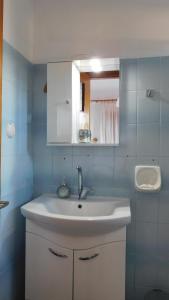 a bathroom with a white sink and a mirror at Thaleia view in Perdika