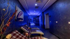 a room with blue walls and couches in a room at Mai İnci Otel in Antalya