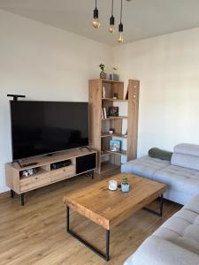 a living room with a large flat screen tv at Apartman Usmev in Košice