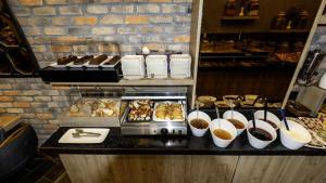 a bakery with a counter with pastries and other food at Mai İnci Otel in Antalya