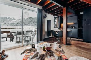 a living room with a table and a dining room at ISKÖ BaseCamp & Hôtel, Col d'Aubisque in Gourette