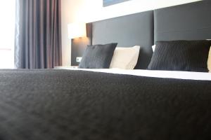 Postel nebo postele na pokoji v ubytování Hotel M