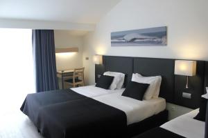 Postel nebo postele na pokoji v ubytování Hotel M