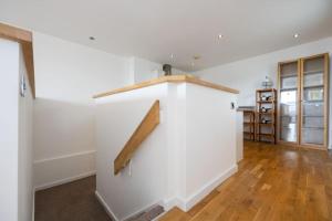 an empty room with a white wall with a wooden rail at Stunning Duplex Apartment, Free Parking For 2, WI-FI, Central Location, Long Term Disc in Manchester