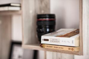 a shelf with two books and a coffee mug at New White Studio F next to Forest the Gondola in Bansko