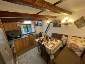 a living room with a couch and a table at Майоровата къща in Shiroka Laka