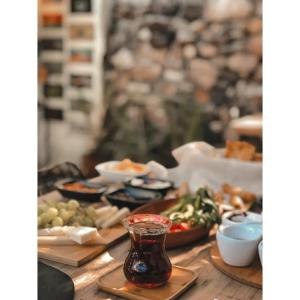a table with plates of food and a drink at La Luna Otel Cunda in Ayvalık +41 photos