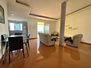 a living room with a dining table and chairs at Cidade Velha - Cathedral and Sea view - 2Bdr Apart - 3 in Cidade Velha