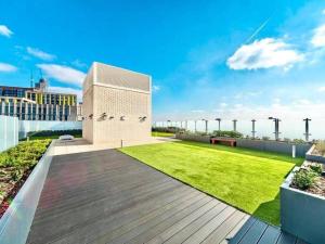 a view of a building with a lawn on a roof at Unique 3BR 3BATH Townhouse Duplex SmartHome in London