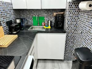 a small kitchen with white cabinets and a sink at Modern premium apt-Europa Apartamentos near CCYumbo in Playa del Ingles