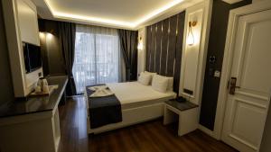 a hotel room with a bed and a window at Mai İnci Otel in Antalya