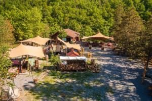 an overhead view of a yard with tables and umbrellas at Rifugio Nido del Biancone in Bosio